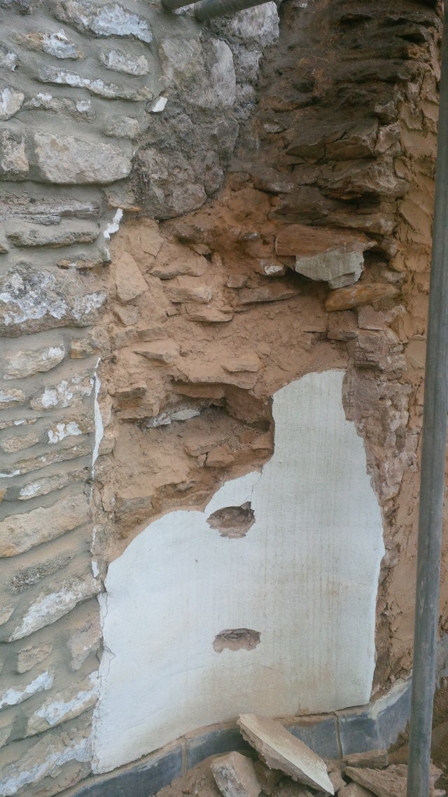 painted cement render over rubble and mud 